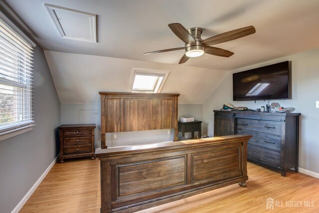 bedroom featuring ceiling fan, light hardwood / wood-style flooring, and lofted ceiling