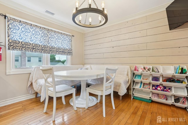 522 Hancock St, Middlesex, NJ 08846 - dining room with a chandelier, ornamental molding, wood walls, and hardwood / wood-style floors