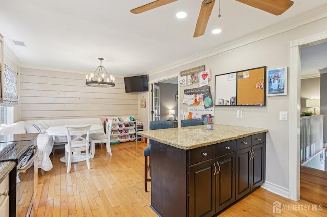 522 Hancock St, Middlesex, NJ 08846 - kitchen with electric stove, ceiling fan, ornamental molding, light wood-type flooring, and a breakfast bar area