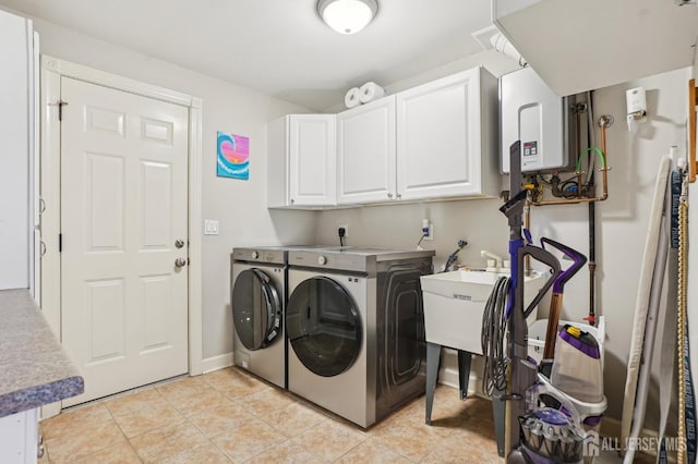 522 Hancock St, Middlesex, NJ 08846 - laundry area featuring washer and dryer, cabinet space, light tile patterned floors, and baseboards
