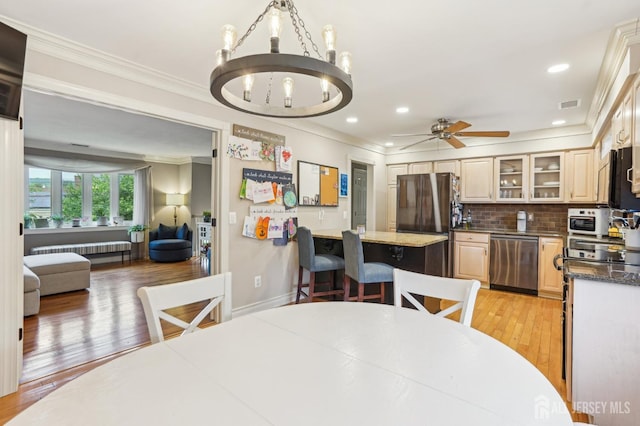 522 Hancock St, Middlesex, NJ 08846 - dining area featuring a chandelier, ornamental molding, light wood-type flooring, a ceiling fan, and radiator heating unit