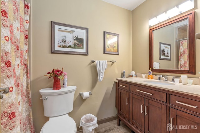 bathroom featuring vanity, baseboards, a shower with curtain, and toilet