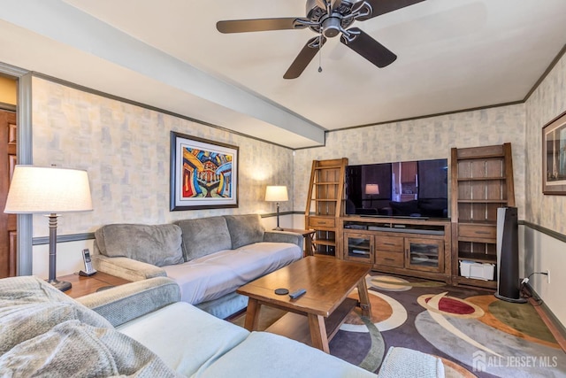 living area with baseboards, wallpapered walls, and a ceiling fan