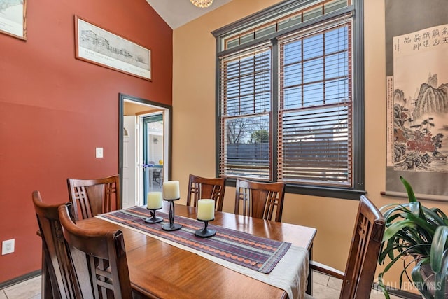 dining area with baseboards and light tile patterned flooring