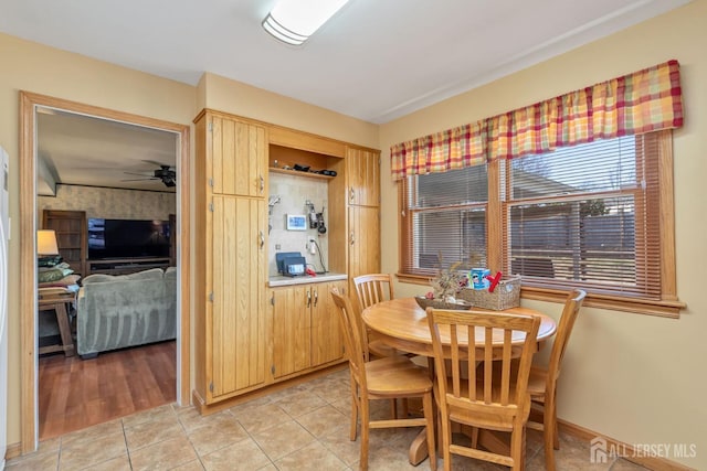 dining room featuring light tile patterned floors, baseboards, and a ceiling fan
