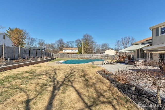 view of swimming pool featuring a fenced in pool, a patio, a diving board, a fenced backyard, and a yard