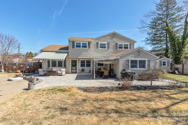 rear view of property featuring a patio, a yard, fence, and roof with shingles