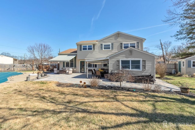 back of property with fence, a patio, a lawn, and roof with shingles
