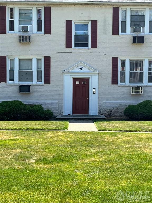 view of exterior entry featuring a yard