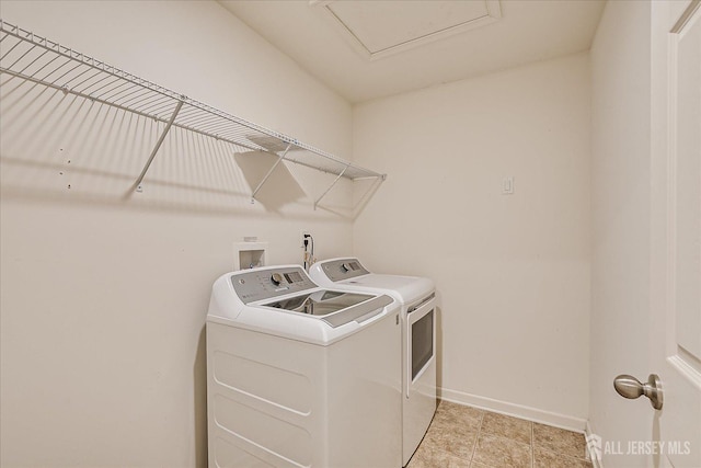 clothes washing area with laundry area, independent washer and dryer, and baseboards