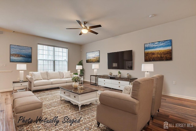 living room with wood finished floors, a ceiling fan, and baseboards