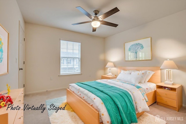 bedroom with ceiling fan, baseboards, and light colored carpet