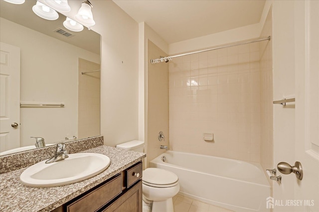 full bathroom featuring bathing tub / shower combination, visible vents, toilet, vanity, and tile patterned floors