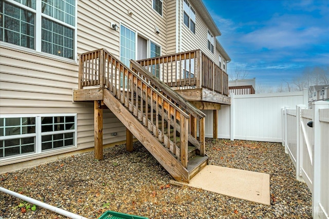 exterior space with a fenced backyard, stairs, and a deck