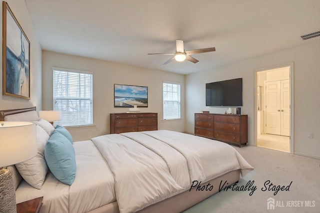 carpeted bedroom featuring ceiling fan, multiple windows, and visible vents