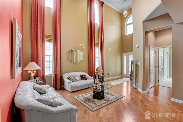 56 Kings Mill Rd, Monroe, NJ 08831 - living room with light wood finished floors, a towering ceiling, baseboards, and ornamental molding