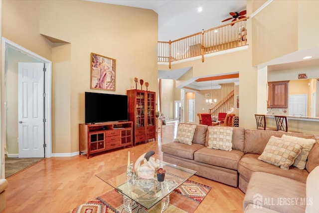 56 Kings Mill Rd, Monroe, NJ 08831 - living area with a towering ceiling, a ceiling fan, wood finished floors, stairway, and baseboards