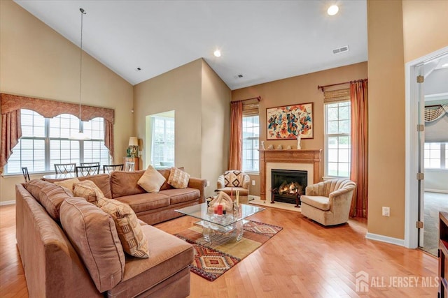 56 Kings Mill Rd, Monroe, NJ 08831 - living room featuring light wood-style flooring, a glass covered fireplace, baseboards, high vaulted ceiling, and recessed lighting