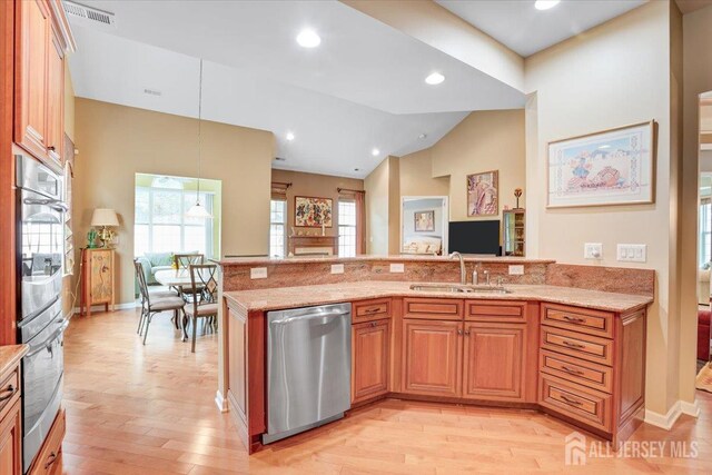 56 Kings Mill Rd, Monroe, NJ 08831 - kitchen with appliances with stainless steel finishes, a sink, light stone counters, light wood finished floors, and vaulted ceiling