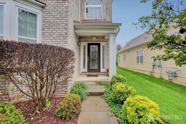 56 Kings Mill Rd, Monroe, NJ 08831 - view of exterior entry featuring brick siding and a lawn