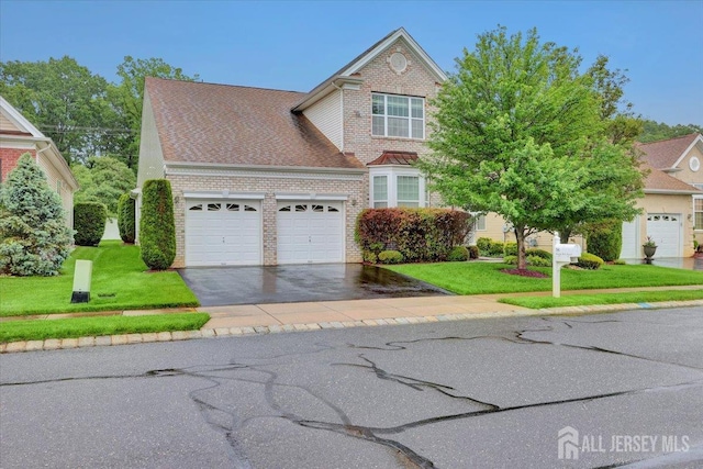 56 Kings Mill Rd, Monroe, NJ 08831 - traditional-style home with an attached garage, driveway, brick siding, and a front lawn