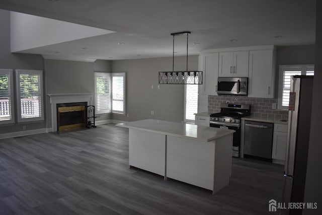 12 Juniper St, Metuchen, NJ 08840 - kitchen featuring stainless steel appliances, light countertops, dark wood-style flooring, a fireplace with flush hearth, and recessed lighting