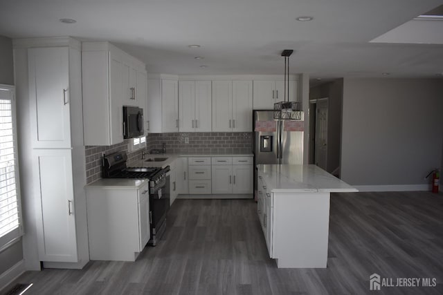 12 Juniper St, Metuchen, NJ 08840 - kitchen featuring stainless steel appliances, wood finished floors, a center island, tasteful backsplash, and recessed lighting