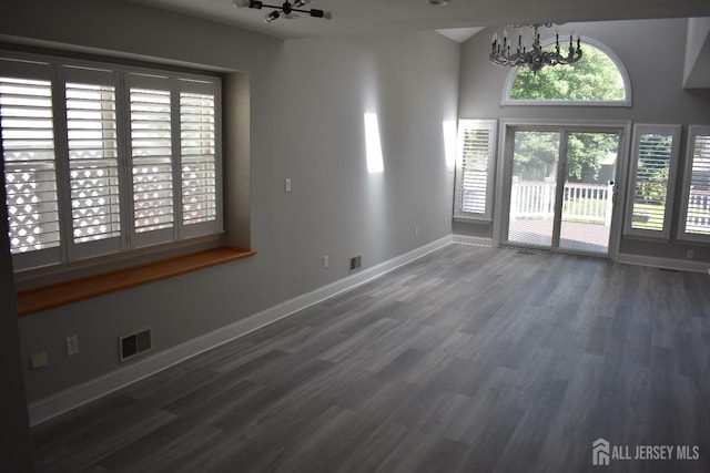 12 Juniper St, Metuchen, NJ 08840 - unfurnished living room featuring a chandelier, wood finished floors, baseboards, and vaulted ceiling