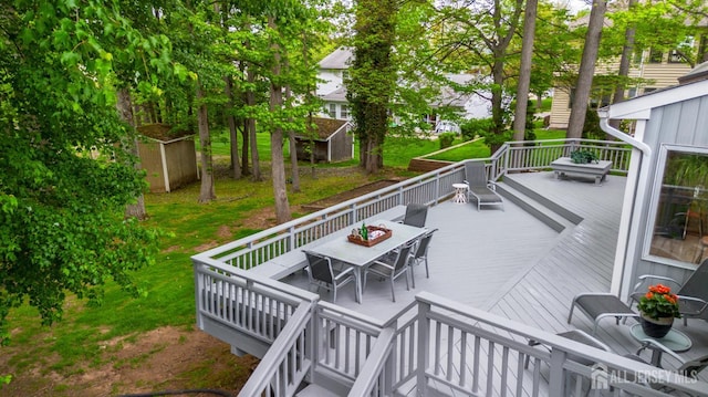 13 Clinton Ave, Edison, NJ 08820 - wooden deck featuring outdoor dining space and a storage unit