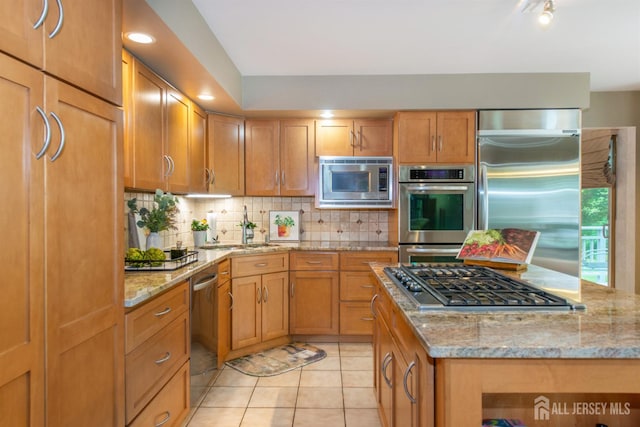 13 Clinton Ave, Edison, NJ 08820 - kitchen featuring built in appliances, a sink, decorative backsplash, light tile patterned floors, and light stone countertops