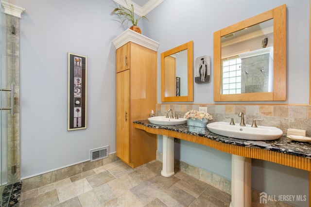 13 Clinton Ave, Edison, NJ 08820 - bathroom with a sink, crown molding, a shower stall, and stone finish flooring