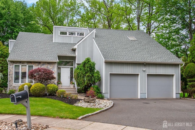 13 Clinton Ave, Edison, NJ 08820 - mid-century modern home with a shingled roof, stone siding, an attached garage, asphalt driveway, and a front lawn
