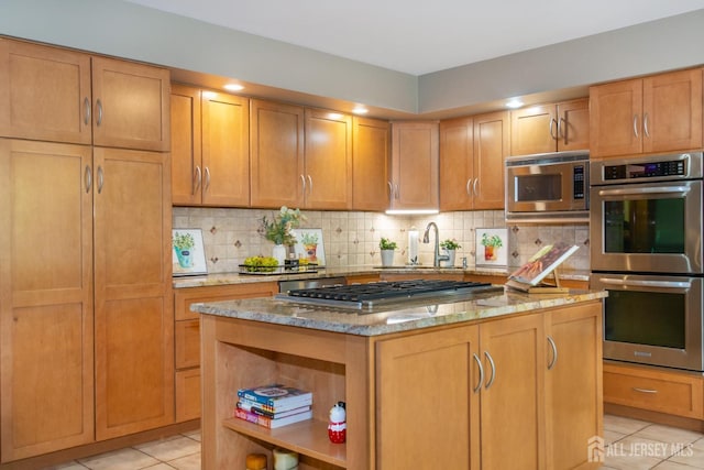 13 Clinton Ave, Edison, NJ 08820 - kitchen with stainless steel appliances, light tile patterned flooring, a sink, light stone counters, and a kitchen island