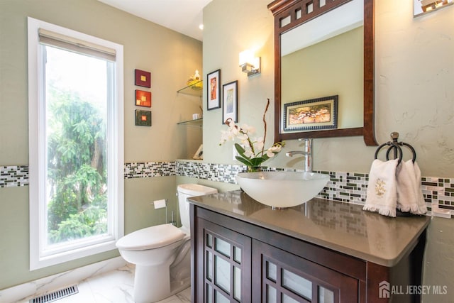 13 Clinton Ave, Edison, NJ 08820 - bathroom with plenty of natural light, vanity, marble look tiles, and toilet