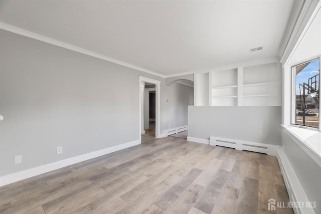 unfurnished room with wood finished floors, visible vents, arched walkways, a baseboard radiator, and baseboard heating