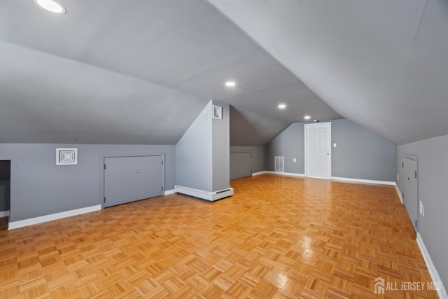 additional living space featuring recessed lighting, vaulted ceiling, visible vents, baseboards, and baseboard heating