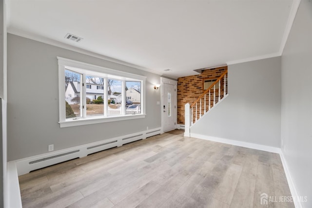 foyer featuring light hardwood / wood-style floors, crown molding, and a baseboard heating unit