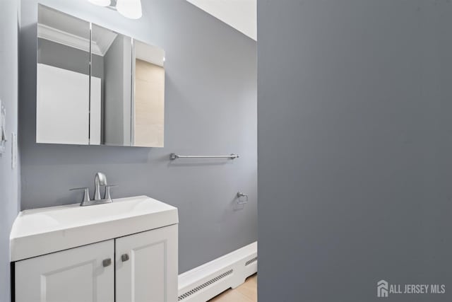 bathroom with baseboard heating and vanity