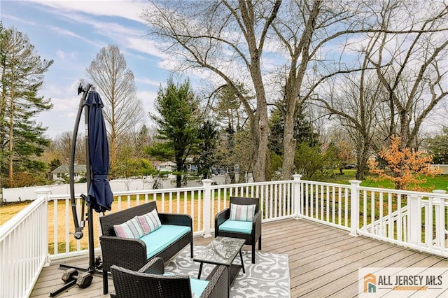 wooden terrace with an outdoor living space
