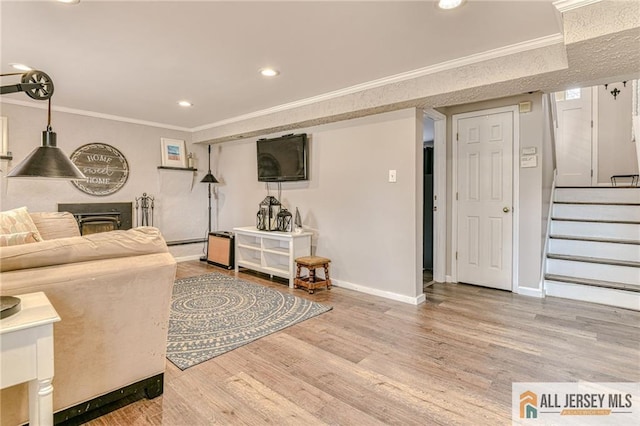 living room featuring crown molding, baseboards, stairway, wood finished floors, and recessed lighting
