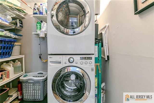 laundry area with stacked washing machine and dryer