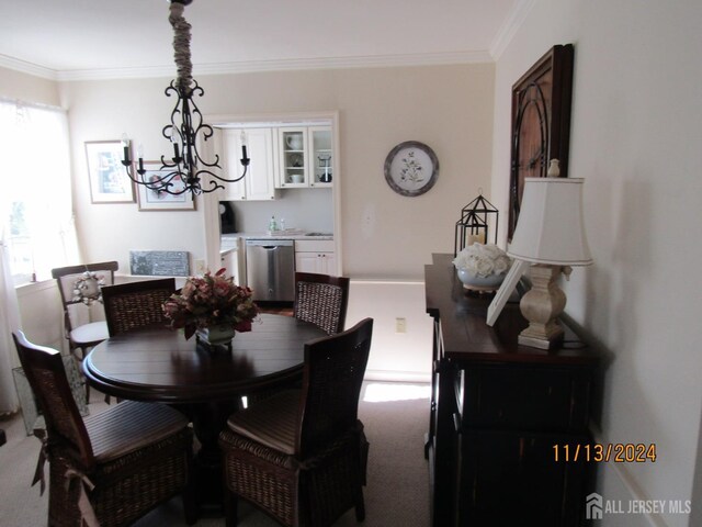 carpeted dining space with crown molding, plenty of natural light, and a notable chandelier