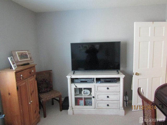 sitting room featuring light colored carpet