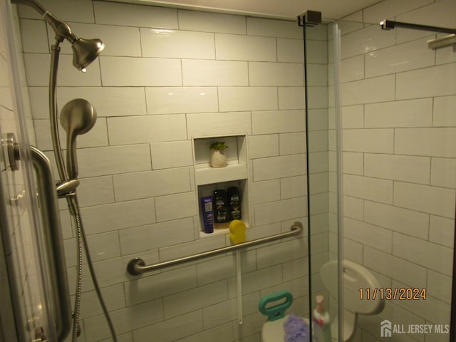 bathroom featuring a shower stall and toilet