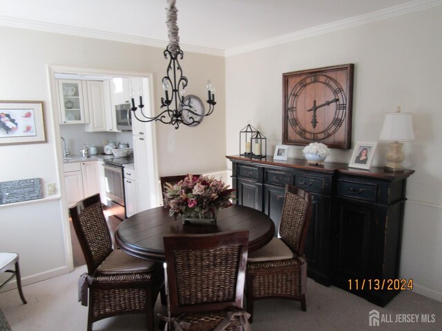 dining area with light carpet, a notable chandelier, and ornamental molding