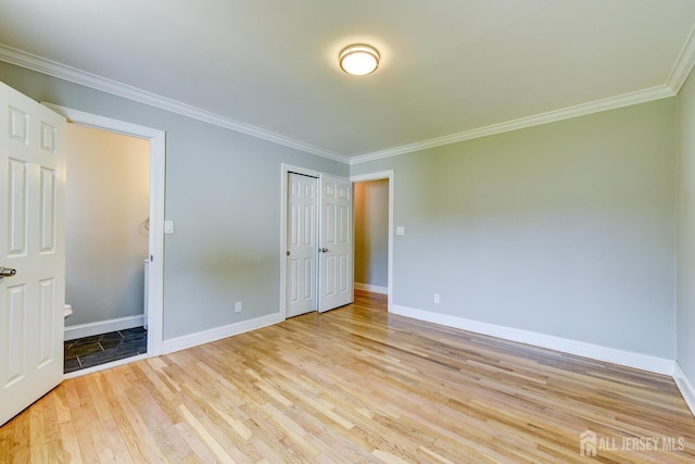 21 Princeton Rd, Old Bridge, NJ 08859 - unfurnished bedroom with light wood-style floors, ornamental molding, and a closet