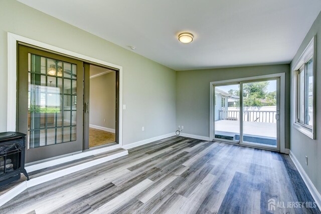 21 Princeton Rd, Old Bridge, NJ 08859 - spare room with a wood stove and wood finished floors