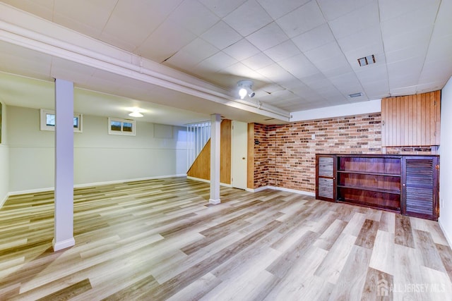 21 Princeton Rd, Old Bridge, NJ 08859 - finished below grade area with brick wall, wood finished floors, and stairway