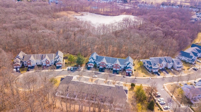 drone / aerial view with a residential view and a wooded view