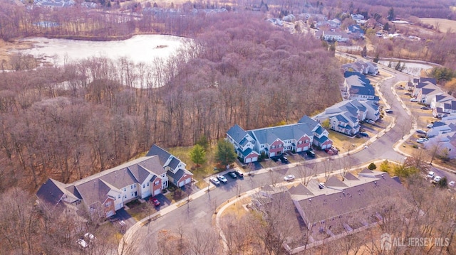 birds eye view of property with a residential view and a wooded view